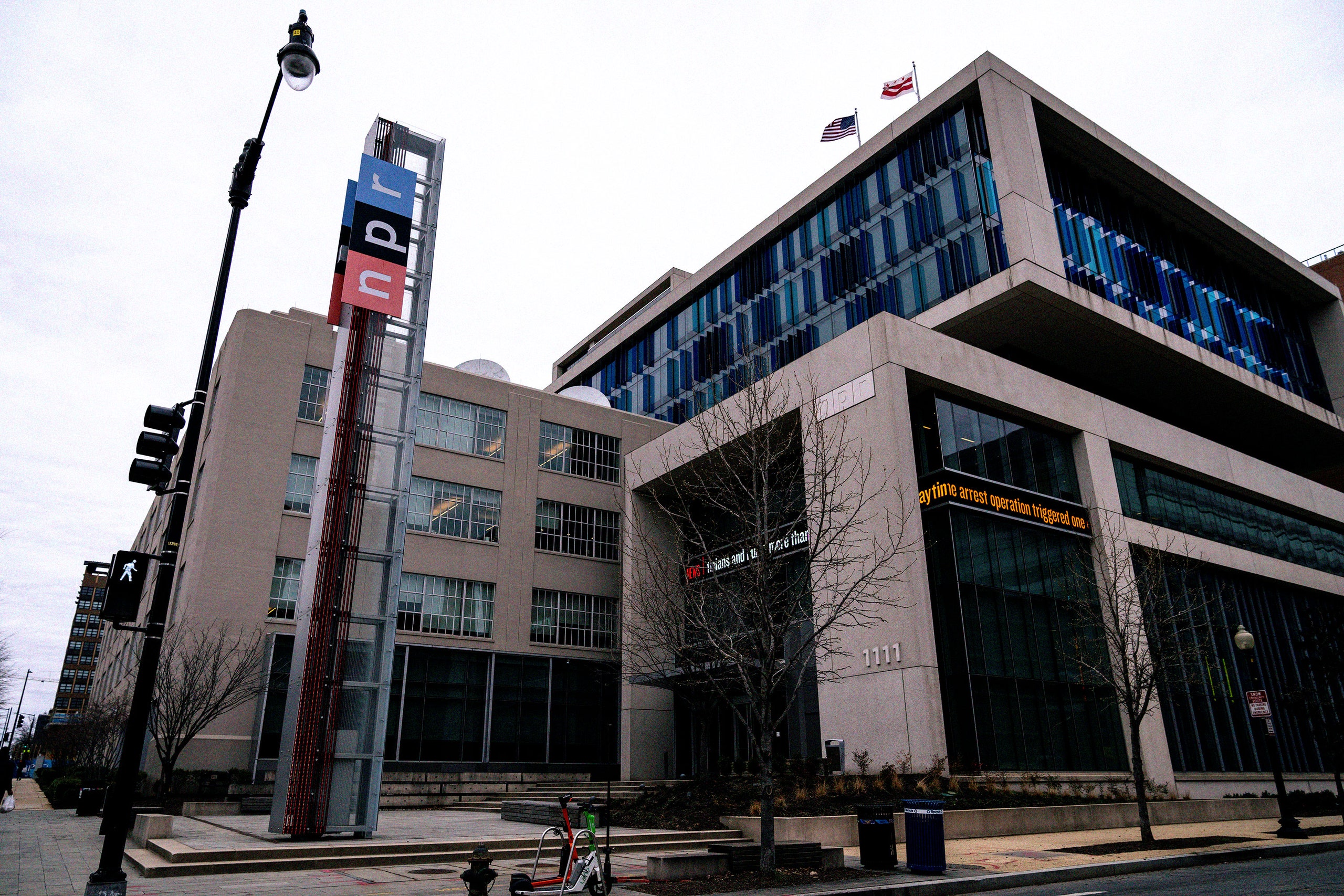 NPR - Image may contain Architecture Building Office Building City Flag Light Traffic Light Urban and Convention Center